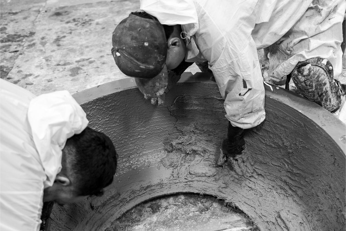 Hand-sanding a fluted concrete panel